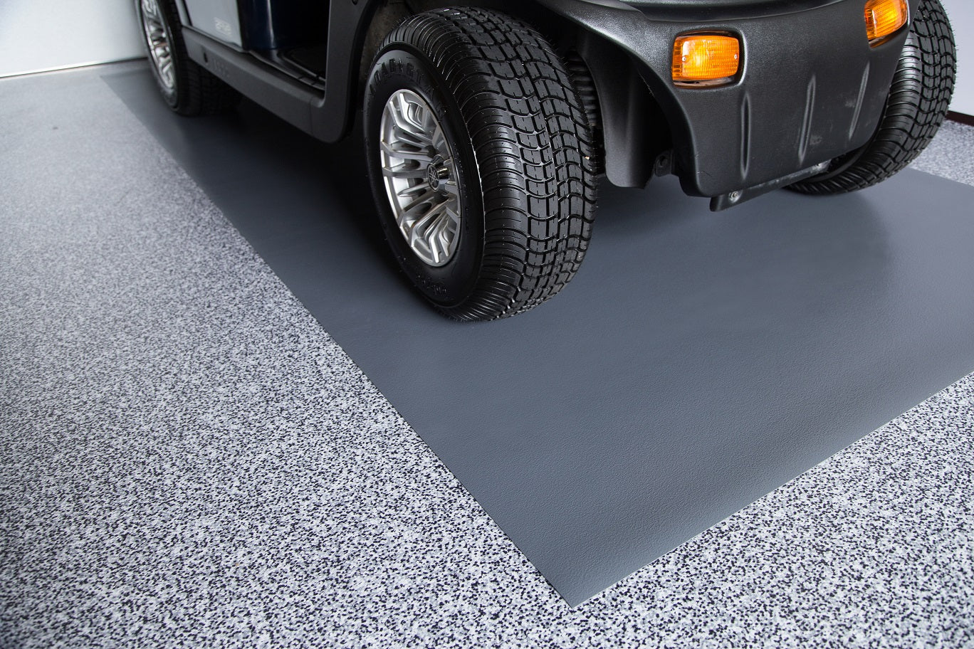 Golf cart on top of Slate Grey Ceramic texture vinyl golf cart mat